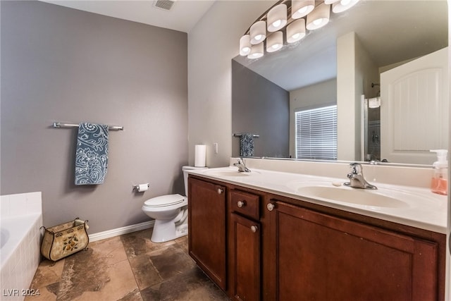 bathroom with vanity, tiled bath, and toilet