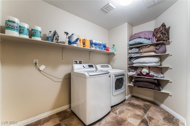 clothes washing area with washing machine and clothes dryer