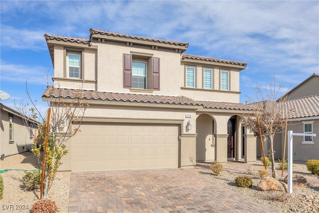 mediterranean / spanish house featuring a garage