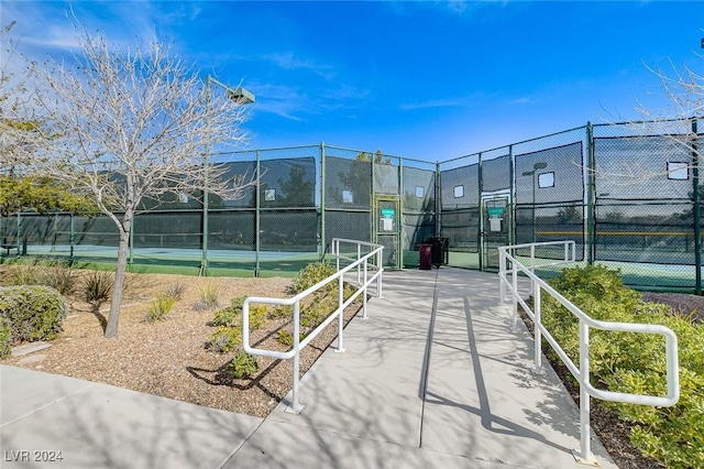 7457 Widewing Dr, North Las Vegas, NV 89084 - view of community featuring a tennis court, fence, and a gate