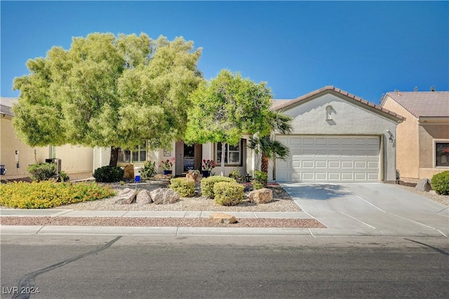7457 Widewing Dr, North Las Vegas, NV 89084 - view of front of home with an attached garage, concrete driveway, and stucco siding