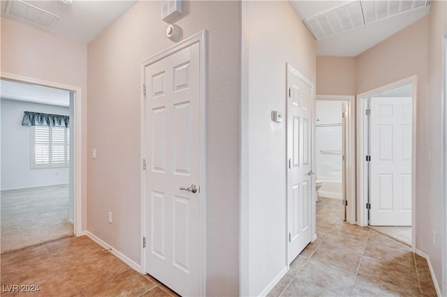 7457 Widewing Dr, North Las Vegas, NV 89084 - hallway featuring light tile patterned floors and baseboards
