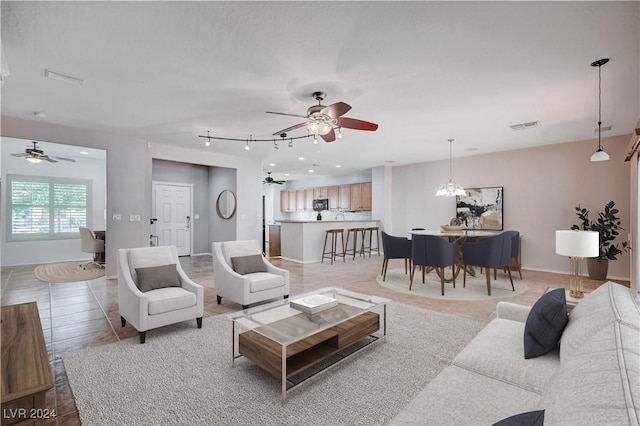7457 Widewing Dr, North Las Vegas, NV 89084 - living area with a ceiling fan and light tile patterned flooring