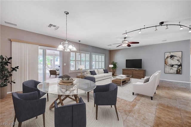 7457 Widewing Dr, North Las Vegas, NV 89084 - living room with a chandelier, ceiling fan, and light tile patterned floors