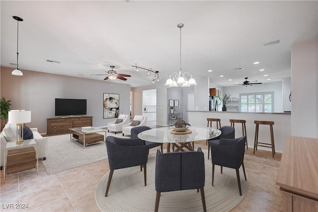 7457 Widewing Dr, North Las Vegas, NV 89084 - dining space featuring a ceiling fan, light tile patterned floors, recessed lighting, rail lighting, and a chandelier