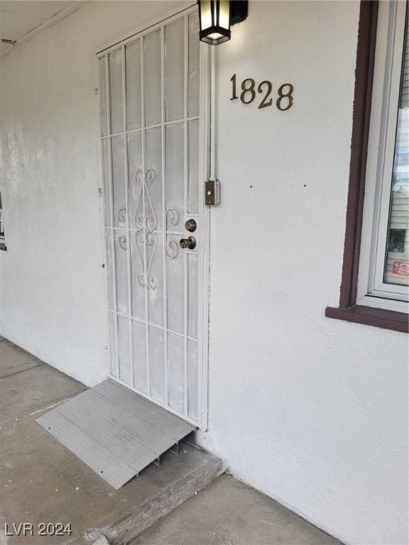 view of exterior entry featuring stucco siding