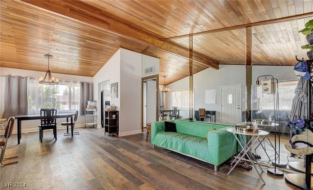 living area with a healthy amount of sunlight, wood finished floors, and an inviting chandelier