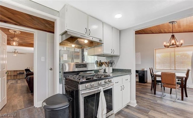 kitchen featuring under cabinet range hood, white cabinets, stainless steel gas range oven, and wood finished floors