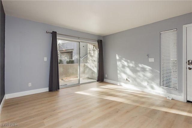 unfurnished room featuring a healthy amount of sunlight and light hardwood / wood-style flooring