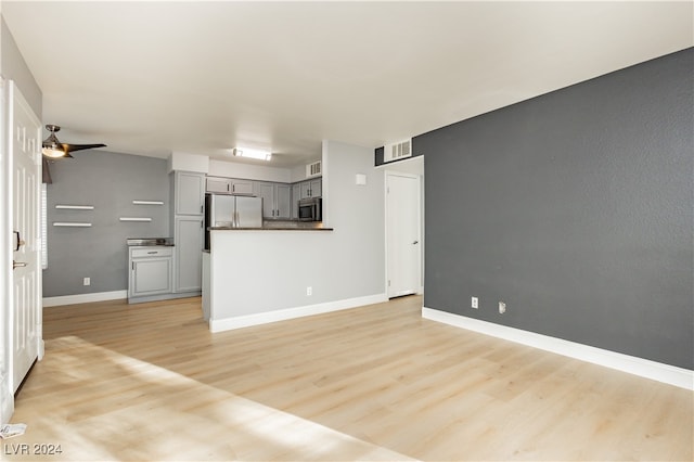 unfurnished living room with light hardwood / wood-style floors and ceiling fan