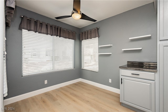 unfurnished dining area with light hardwood / wood-style flooring and ceiling fan