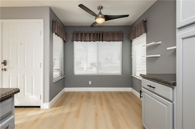 unfurnished dining area featuring ceiling fan and light hardwood / wood-style flooring