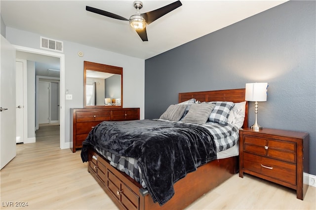 bedroom with ceiling fan and light hardwood / wood-style flooring