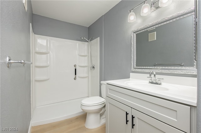 bathroom with hardwood / wood-style flooring, vanity, and toilet