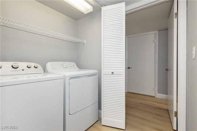 washroom with light wood-type flooring and washer and clothes dryer