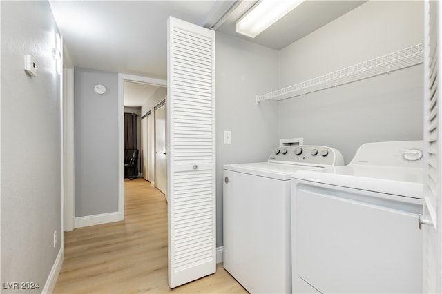 washroom featuring light wood-type flooring and washer and dryer