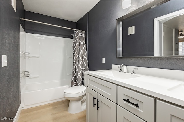 full bathroom with vanity, hardwood / wood-style floors, toilet, and shower / tub combo with curtain