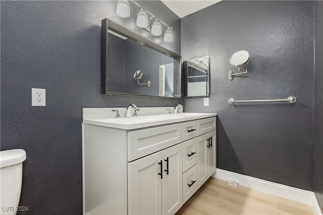 bathroom featuring vanity, toilet, and hardwood / wood-style flooring