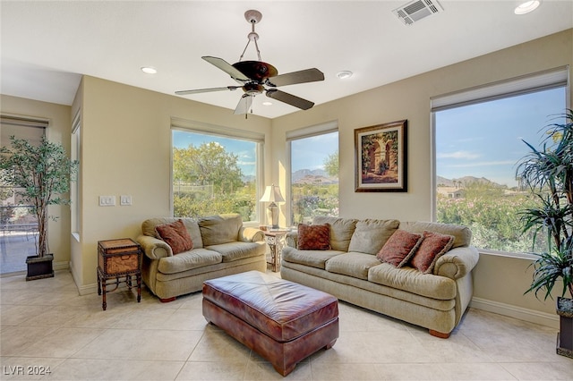 tiled living room featuring a mountain view and ceiling fan