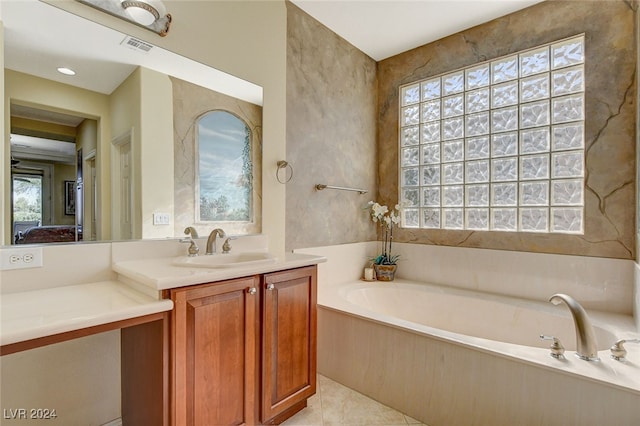 bathroom featuring vanity, a tub to relax in, and tile patterned flooring