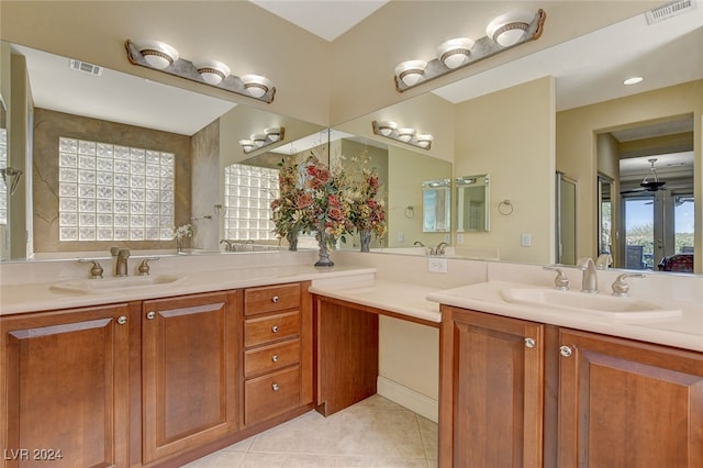 bathroom with a shower, tile patterned flooring, and vanity