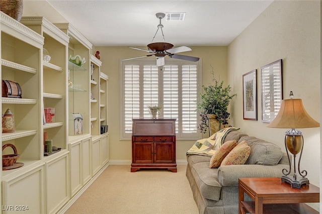 sitting room featuring ceiling fan and light colored carpet