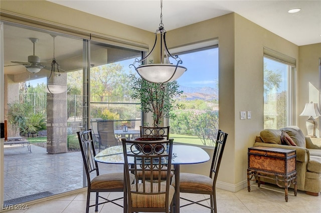 tiled dining room featuring ceiling fan