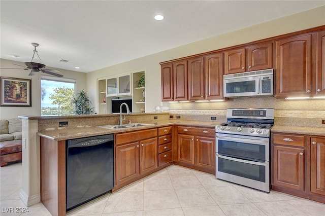 kitchen with kitchen peninsula, sink, ceiling fan, and stainless steel appliances