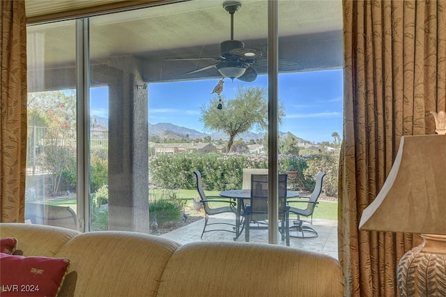 interior space featuring a mountain view, ceiling fan, and plenty of natural light