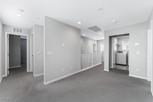 empty room featuring carpet flooring and washer / clothes dryer