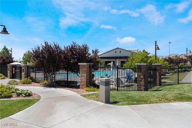 surrounding community with a lawn and a swimming pool