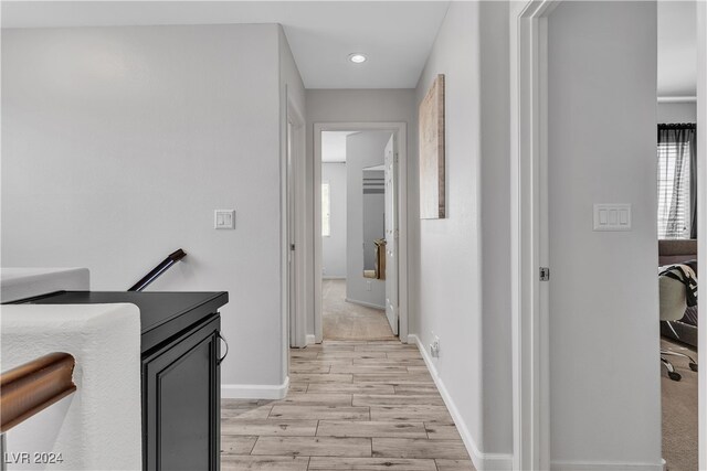 corridor with light hardwood / wood-style flooring