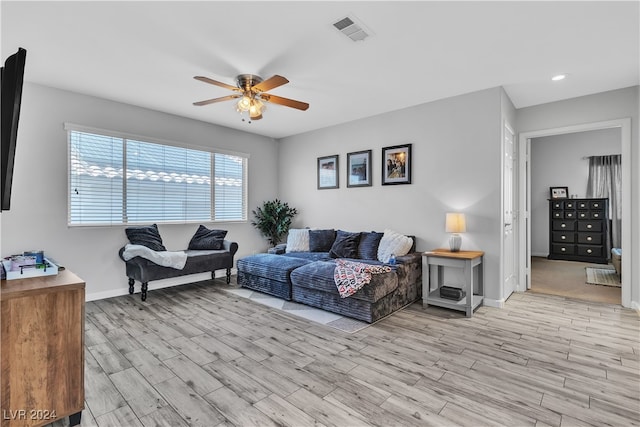 living room featuring ceiling fan and light hardwood / wood-style flooring