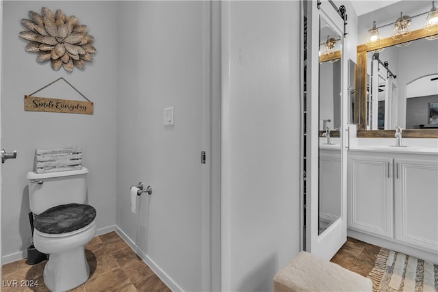 bathroom with vanity and toilet