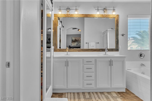 bathroom featuring vanity and shower with separate bathtub