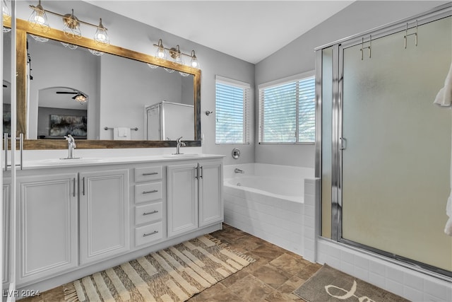 bathroom with vaulted ceiling, independent shower and bath, and vanity