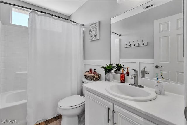 full bathroom featuring wood-type flooring, vanity, toilet, and shower / tub combo