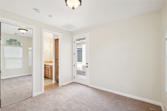 unfurnished bedroom featuring light colored carpet