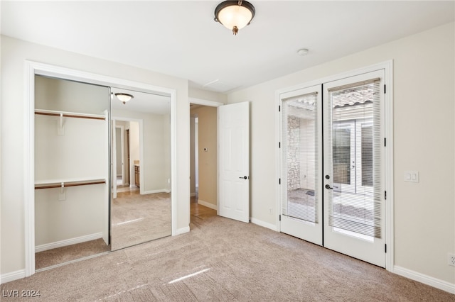 unfurnished bedroom featuring french doors and light colored carpet