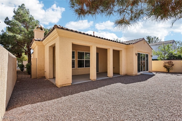 rear view of property featuring a patio area