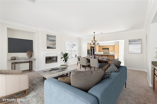 carpeted living room with a notable chandelier and ornamental molding