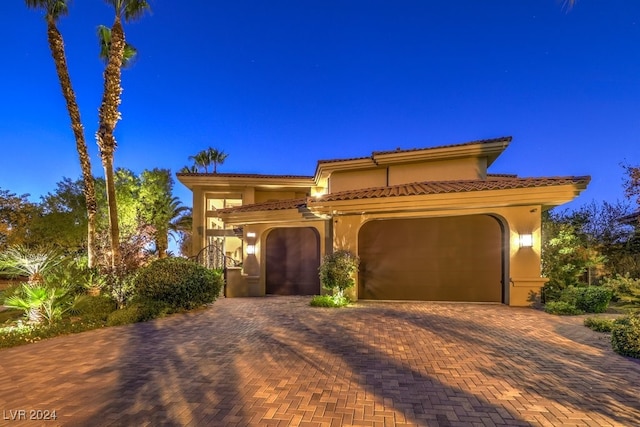 mediterranean / spanish-style home featuring a garage