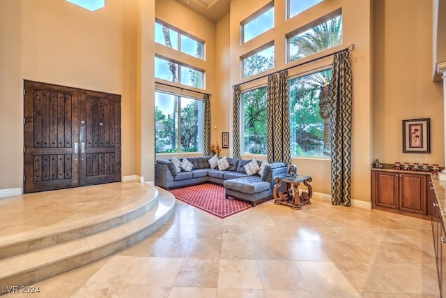 living room featuring a towering ceiling