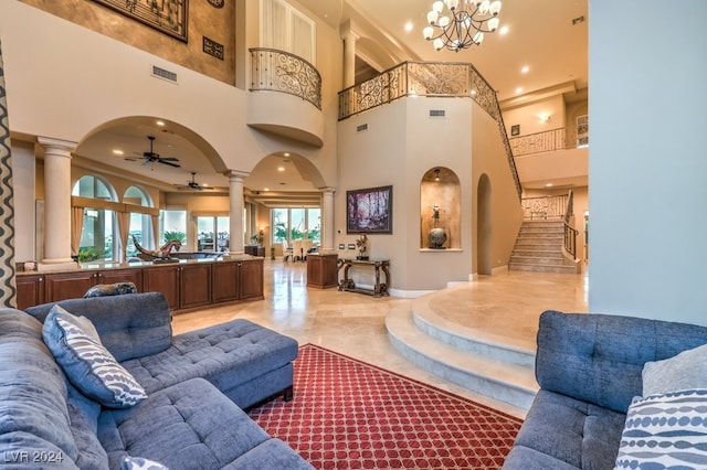 interior space with ceiling fan with notable chandelier and a towering ceiling