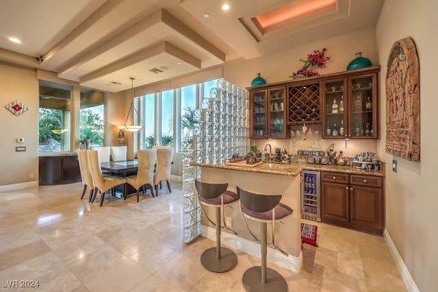 bar with light tile patterned floors, pendant lighting, wine cooler, and light stone counters