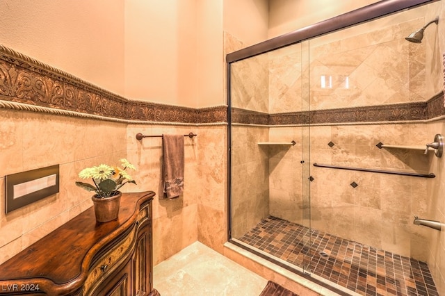 bathroom with walk in shower and tile walls