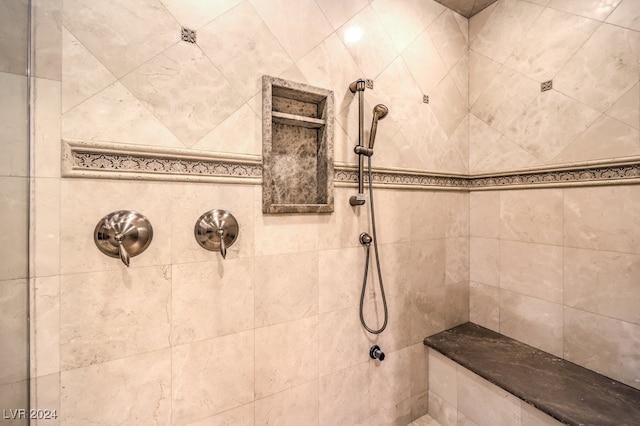 bathroom with tiled shower