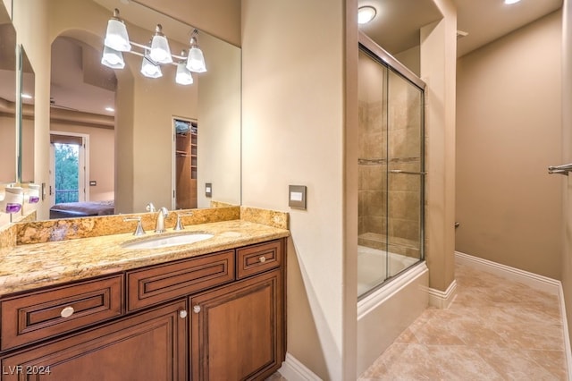 bathroom with shower / bath combination with glass door and vanity