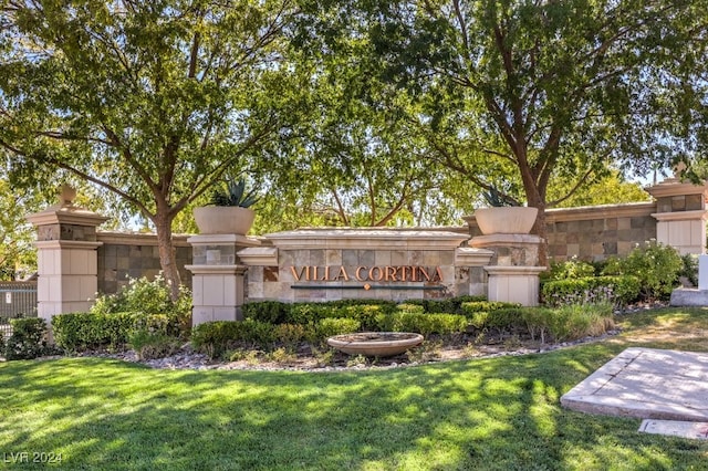 community / neighborhood sign featuring a yard