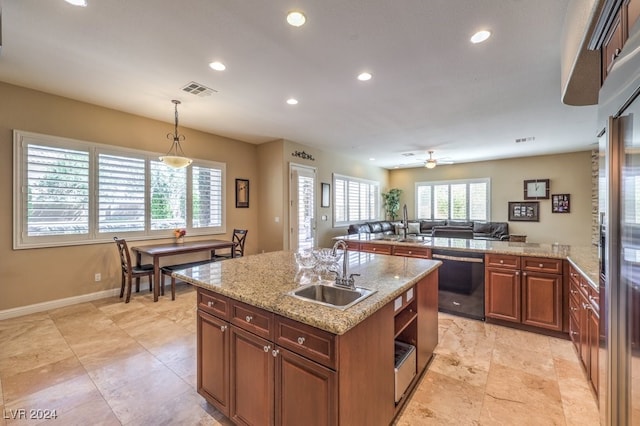 kitchen featuring ceiling fan, pendant lighting, sink, dishwasher, and an island with sink